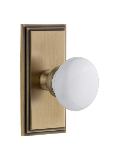 Grandeur Carre Rosette Door Set with Hyde Park White Porcelain Knobs in Antique Brass.